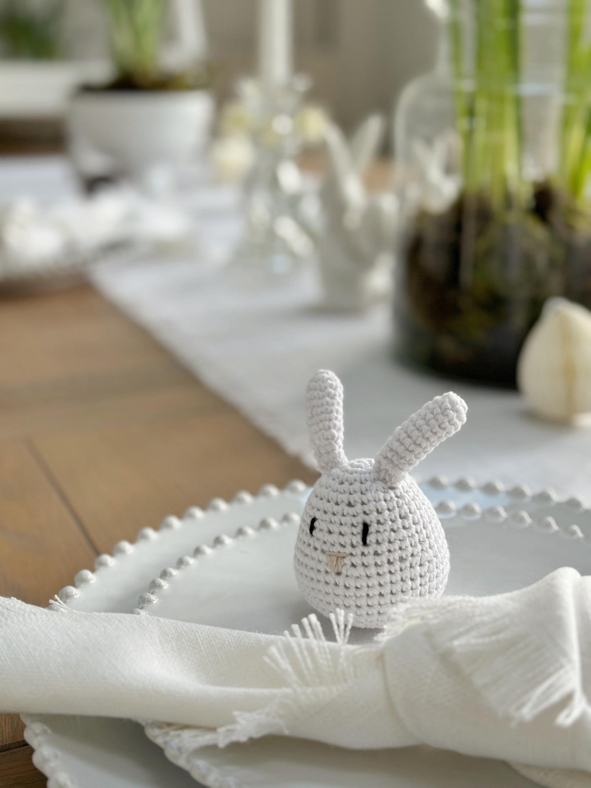 crochet standing bunny on white plates table setting
