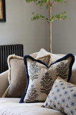 Decorative cushions on a sofa with a neutral background