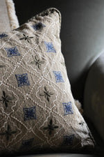 Decorative cushion with intricate patterns on a neutral background