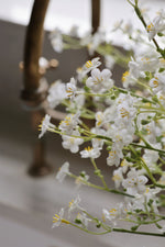 Close-up of white flowers with a blurred background faux forget me not stems