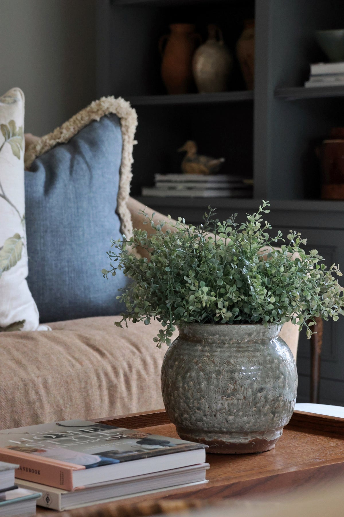 Henley Pot with faux green eucalyptus bush on wooden tray in a living room 