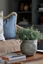 Henley Pot with faux green eucalyptus bush on wooden tray in a living room 