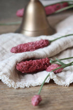 faux Pink flowers on a white cloth with a blurred background
