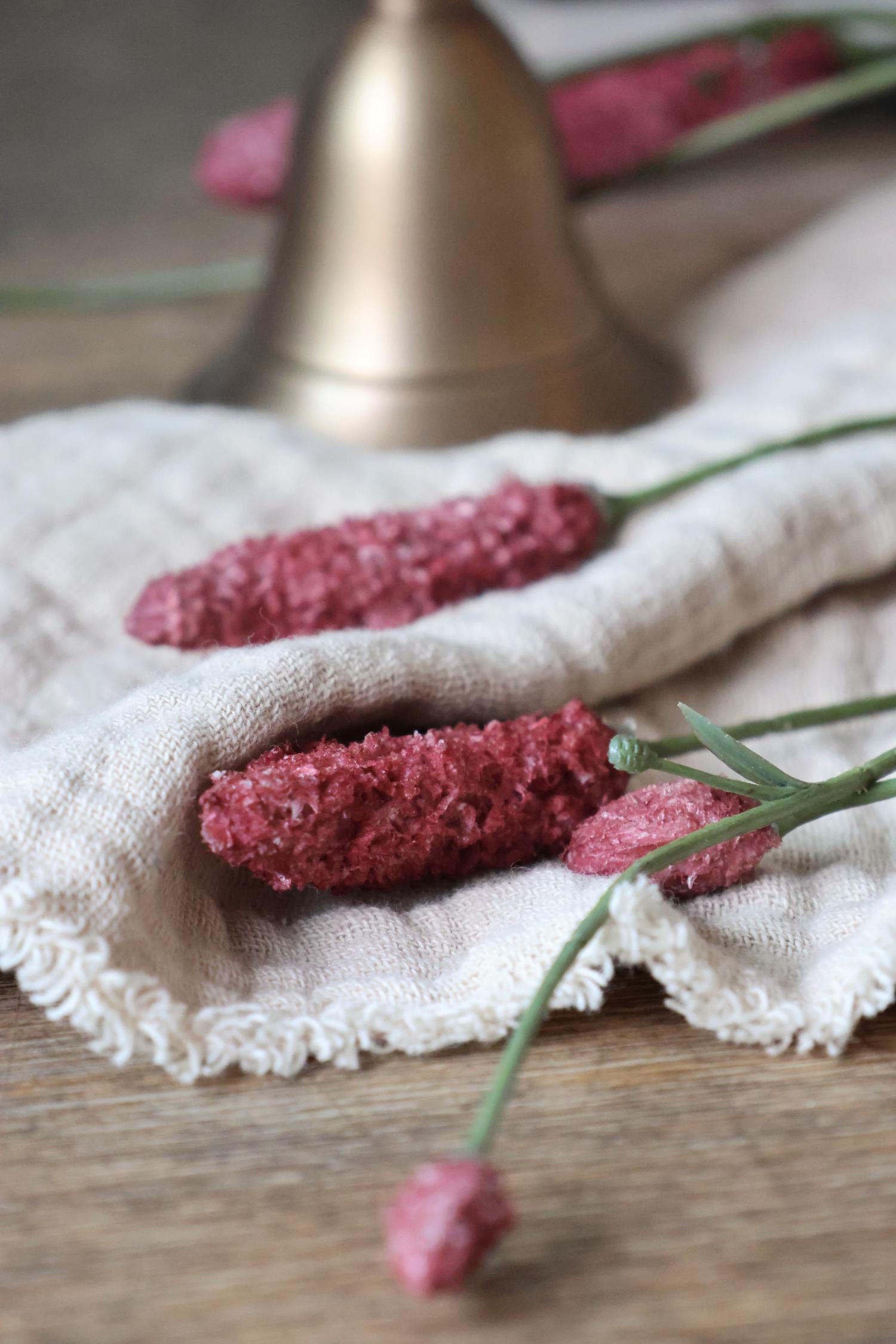 faux Pink flowers on a white cloth with a blurred background