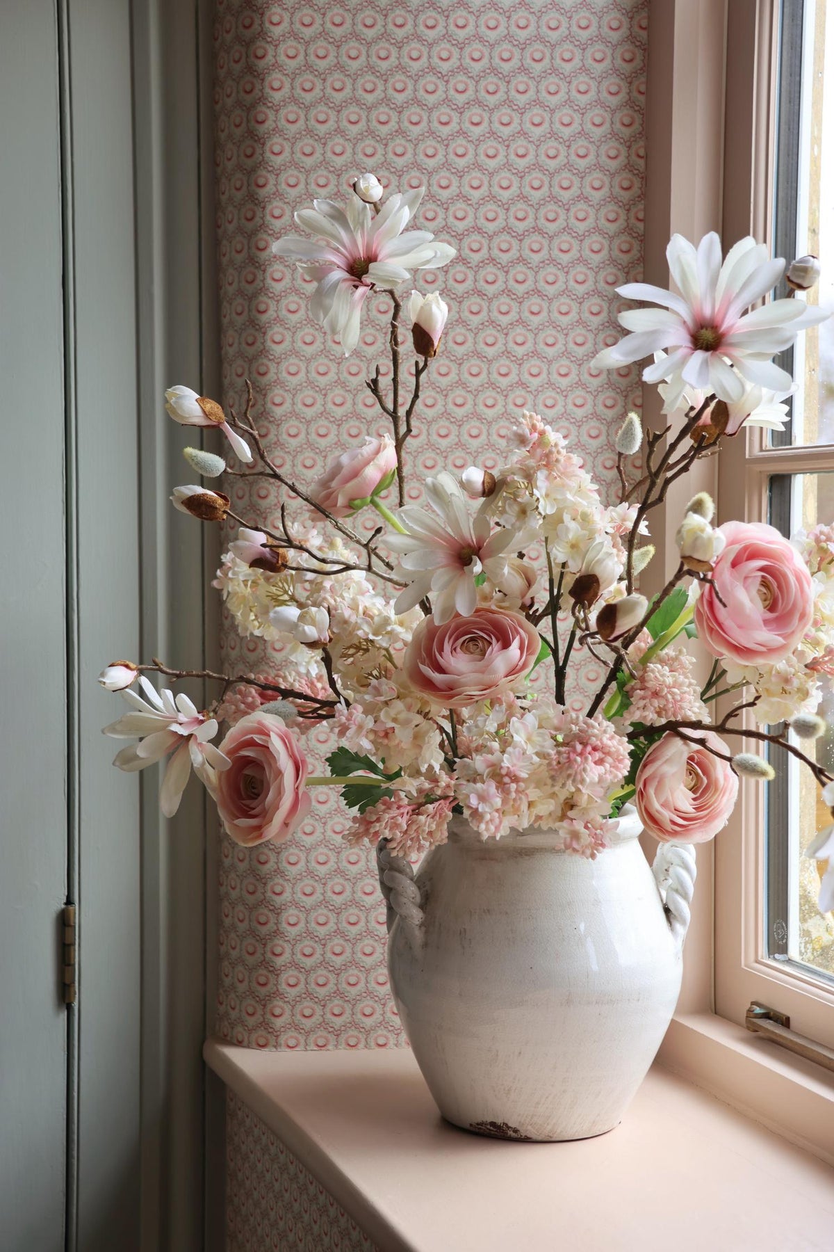 white ceramic vase with powder pink faux arrangement in 