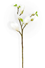 Artificial magnolia stem with white flowers and green leaves on a white background