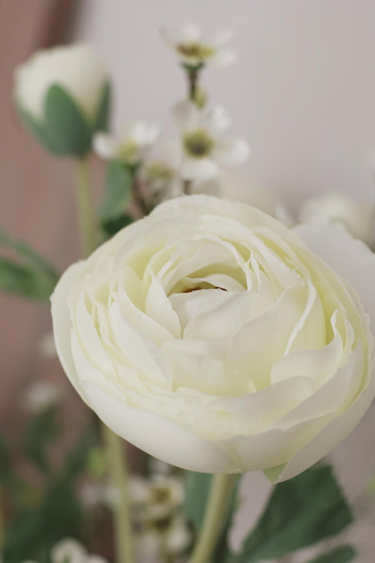 close up of an artificial white ranunculus flower