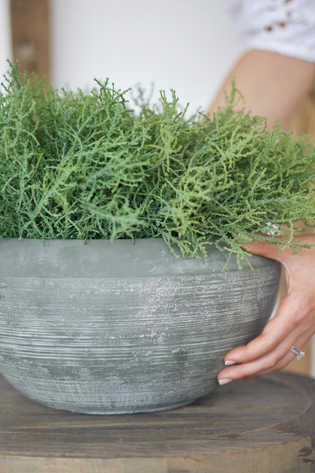 close up of grey pot texture and faux green spanish moss