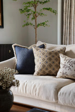 Beige sofa with decorative cushions in a living room setting