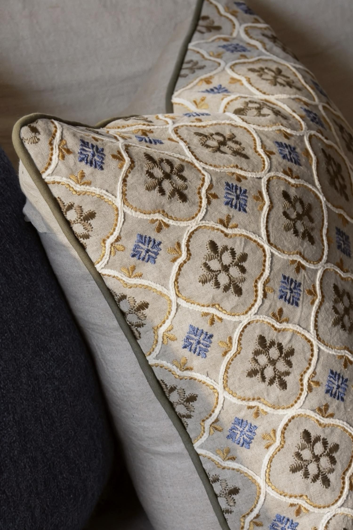 Decorative cushion with floral geometric pattern on a textured surface