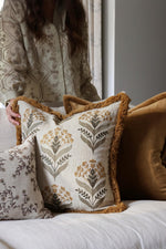 Decorative cushions with floral patterns on a sofa