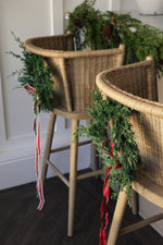 artificial cypress wreaths mini on back of rattan chairs with hanging red ribbon 