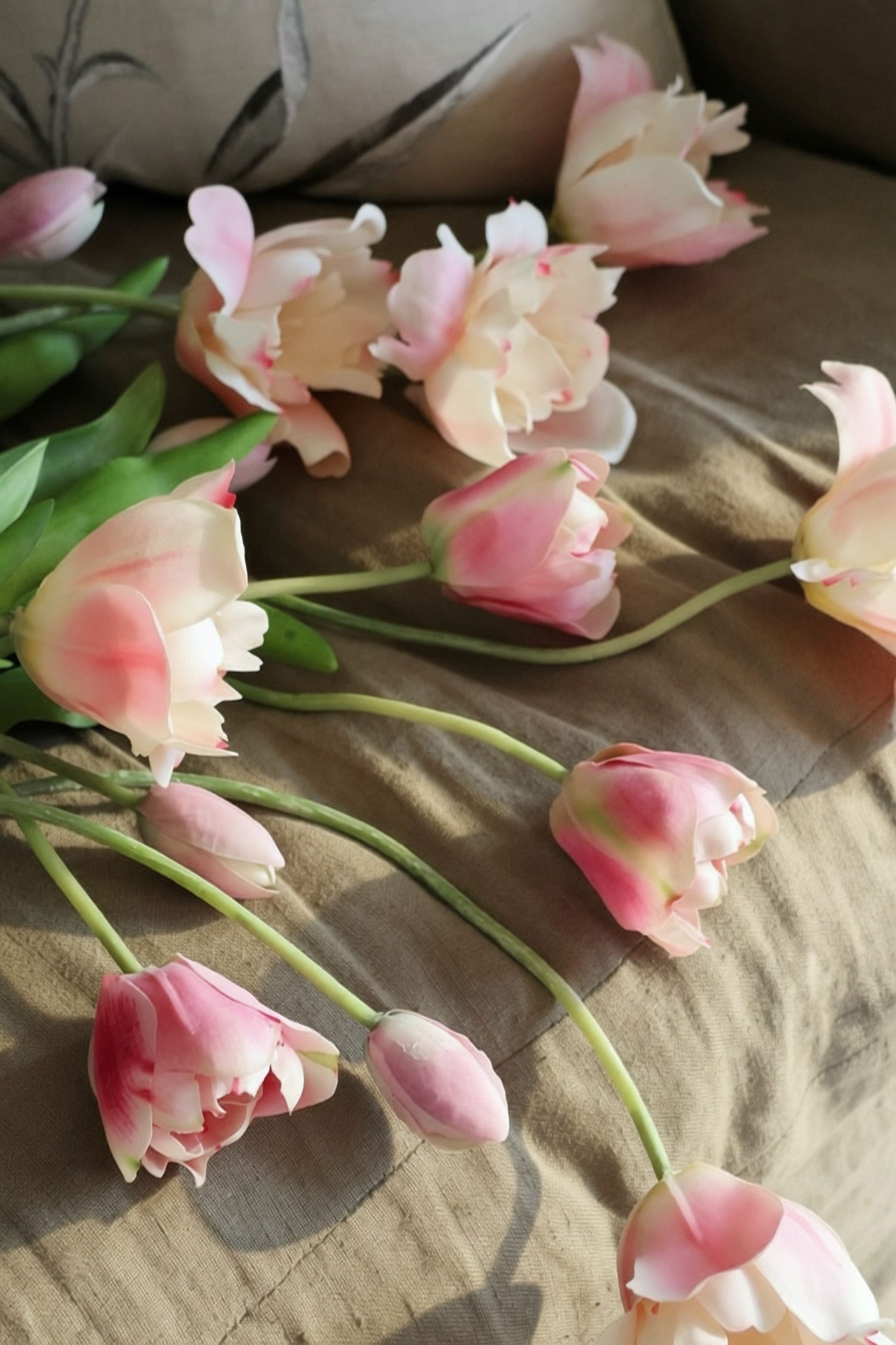 Pink tulips on a textured surface