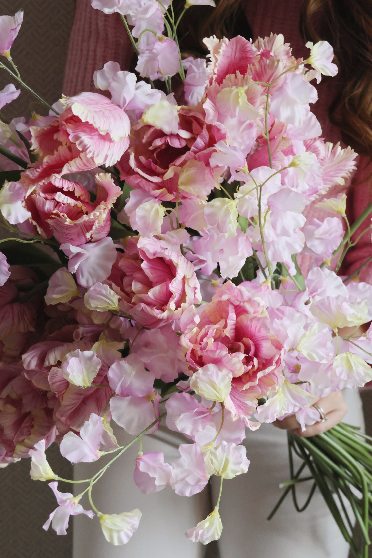 lady holding large bouquet of pink flowers