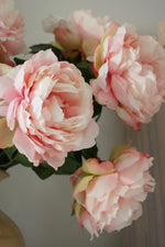Close-up of faux pink peony flowers with a soft focus background