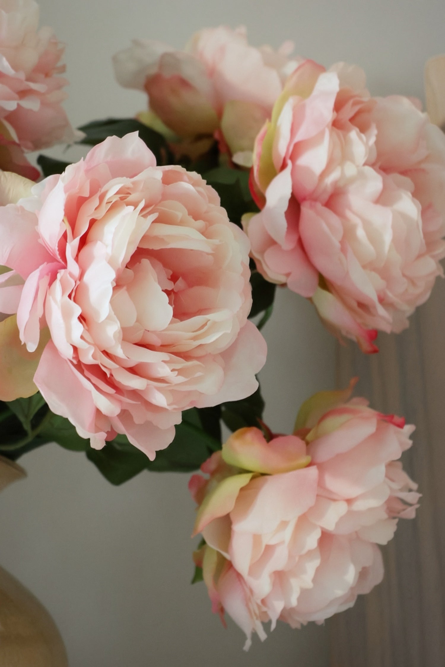 Close-up of faux pink peony flowers with a soft focus background