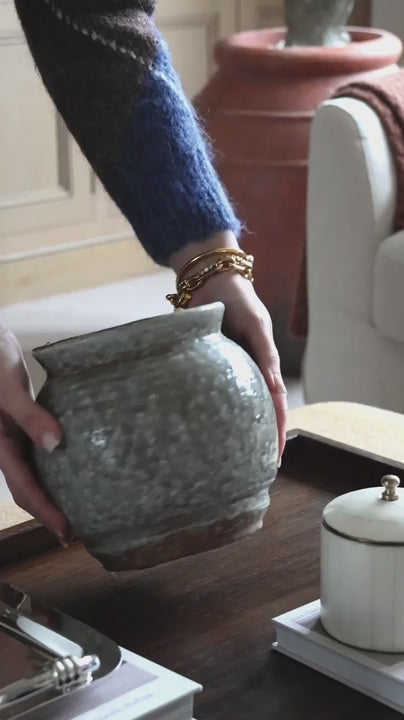 founder, ashlee jane, creating a coffee table arrangement using our henley pot and 3 of our faux eucalyptus bush stems 