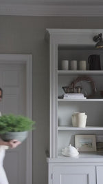 faux potted spanish moss being styled on shelving and coffee table