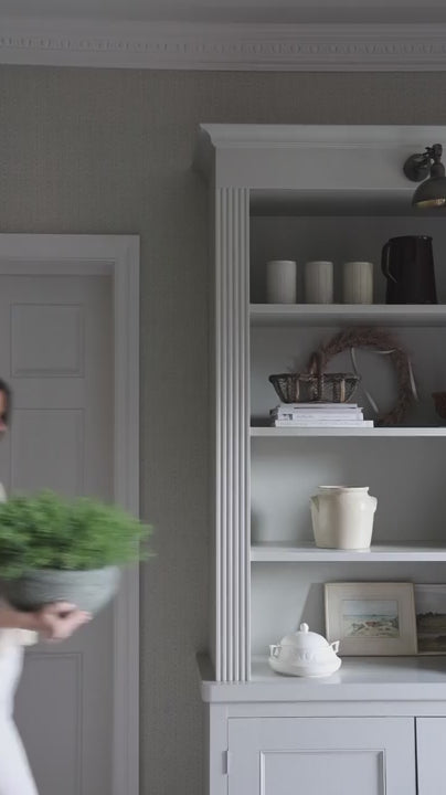 faux potted spanish moss being styled on shelving and coffee table