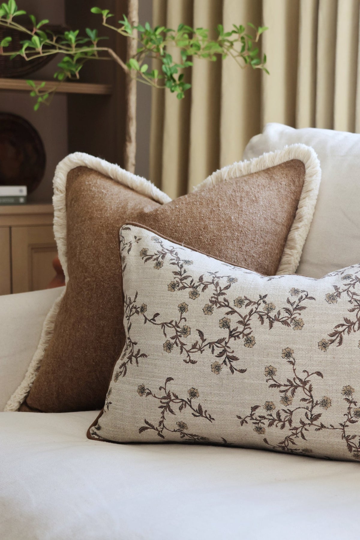 Decorative textured brown cushion on a sofa with a neutral background