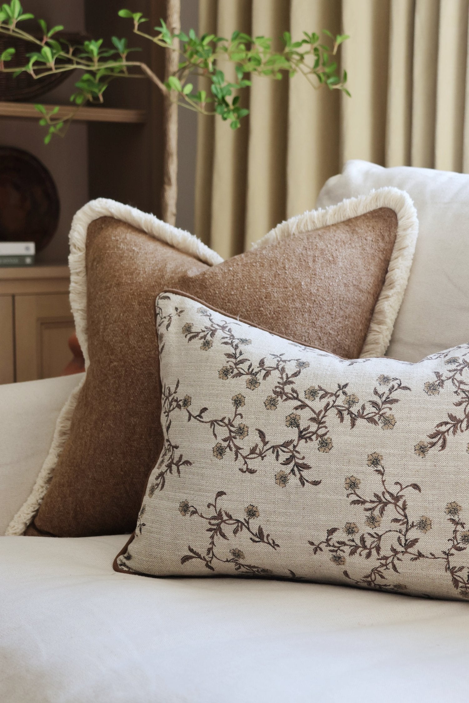 Decorative textured brown cushion on a sofa with a neutral background