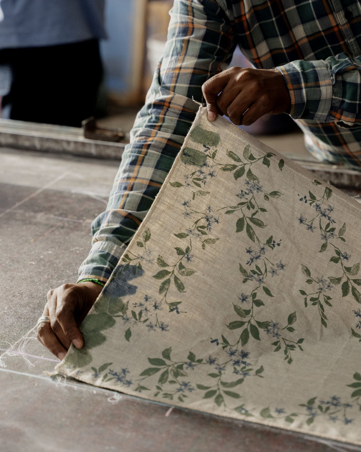 Printed fabric being laid out on a workbench 