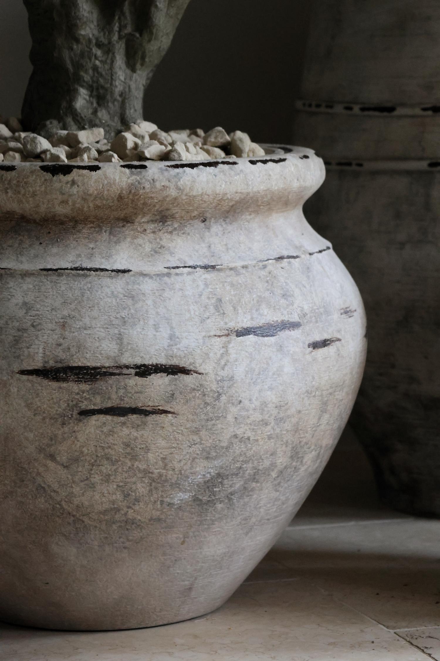 close up of distressed stone effect barrow planter 