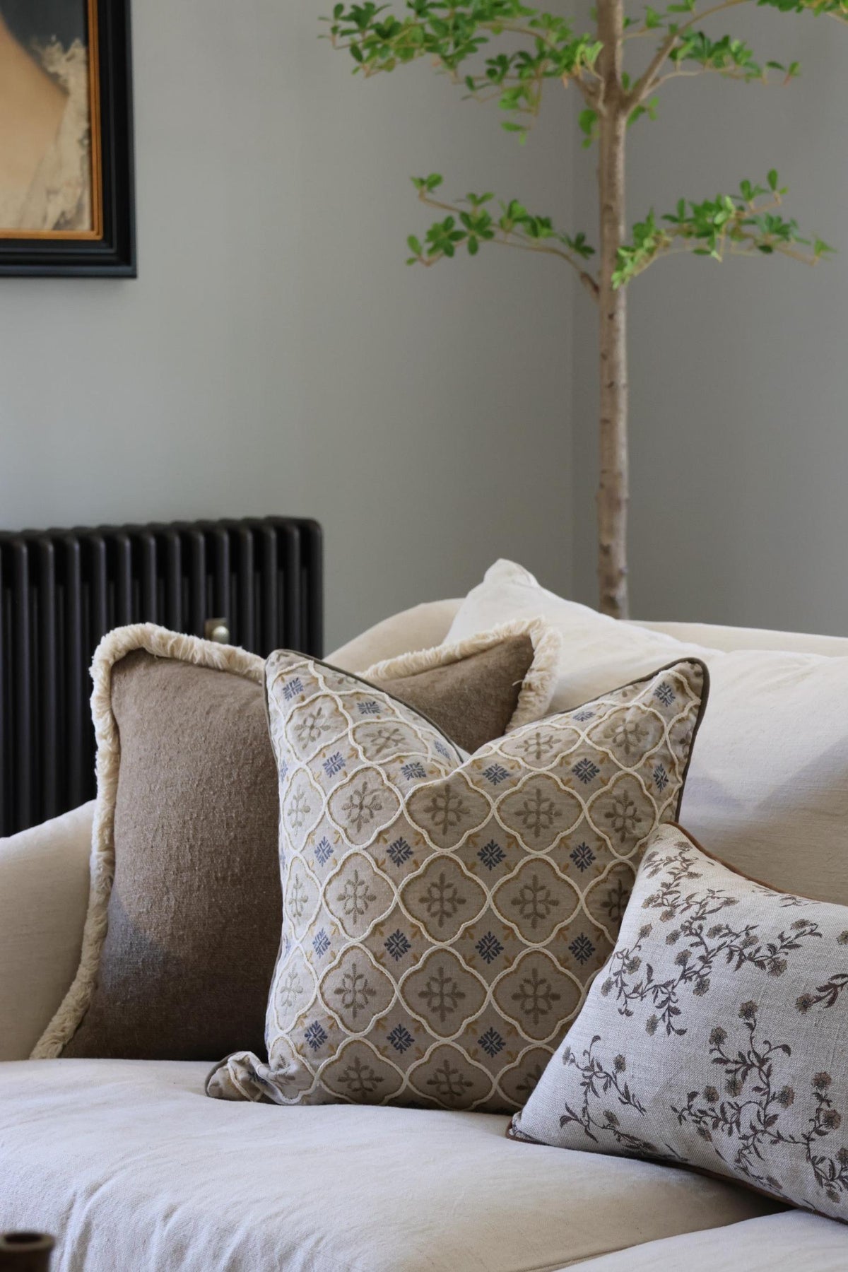 Decorative cushions on a sofa with a neutral background