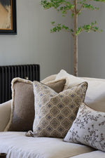 Decorative cushions on a sofa with a neutral background
